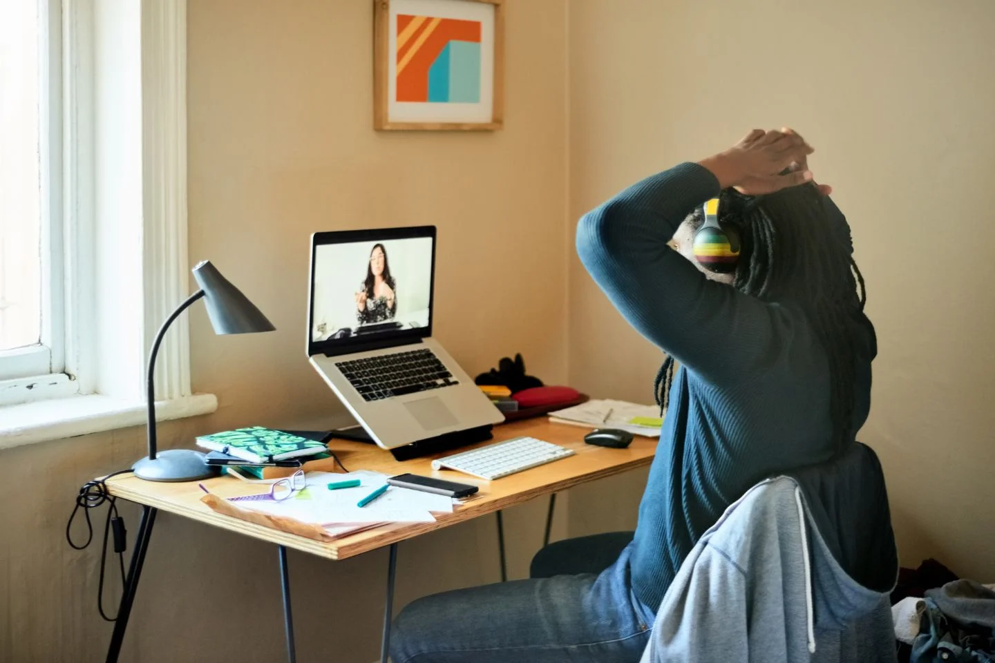 person remotely working on their laptop from their home office