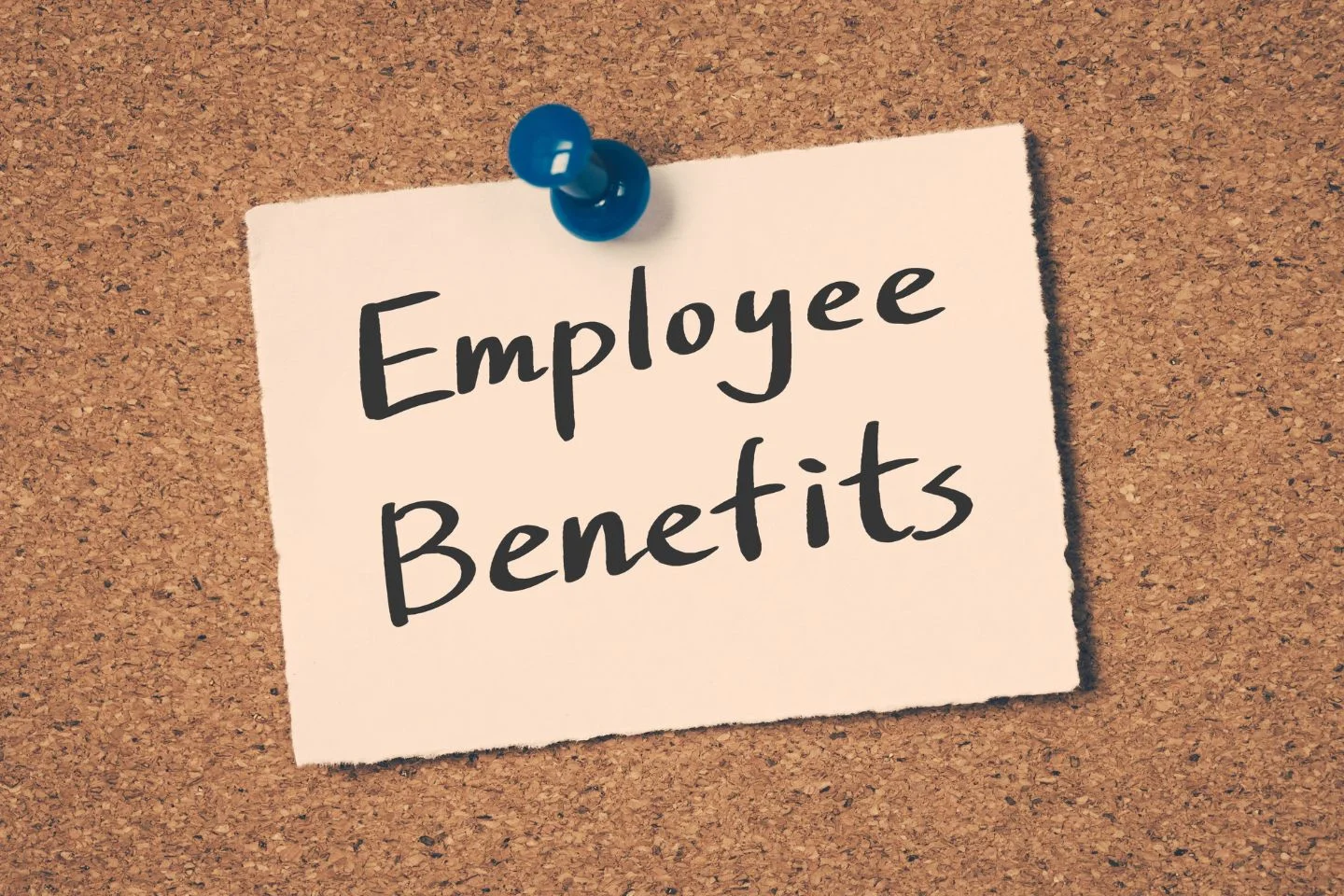 "employee benefits" written on a note, tacked to a corkboard