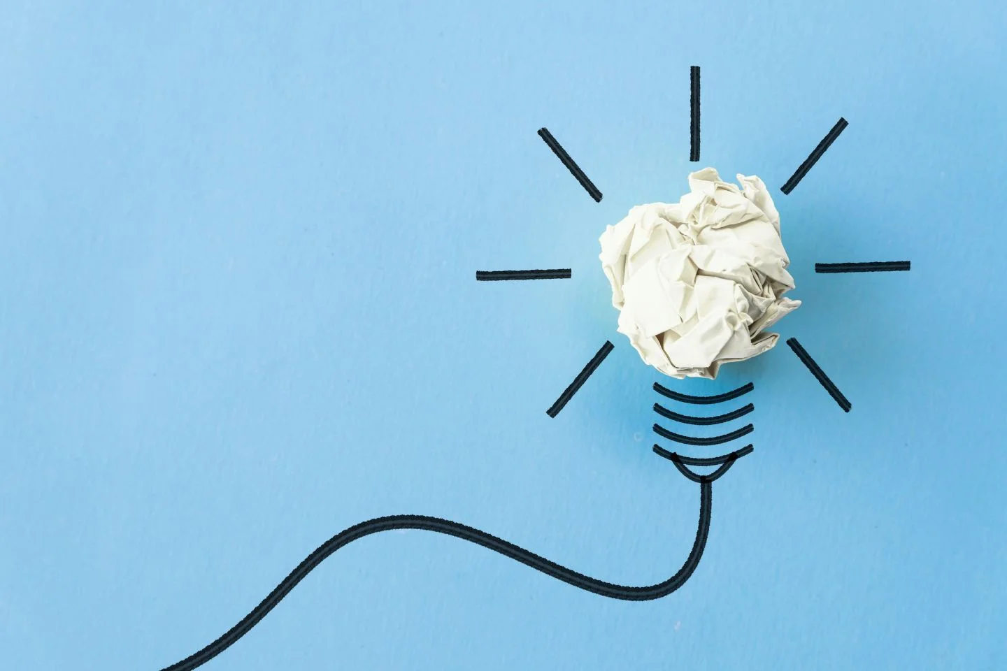 illustration of a lightbulb using a crumpled up piece of paper as the bulb