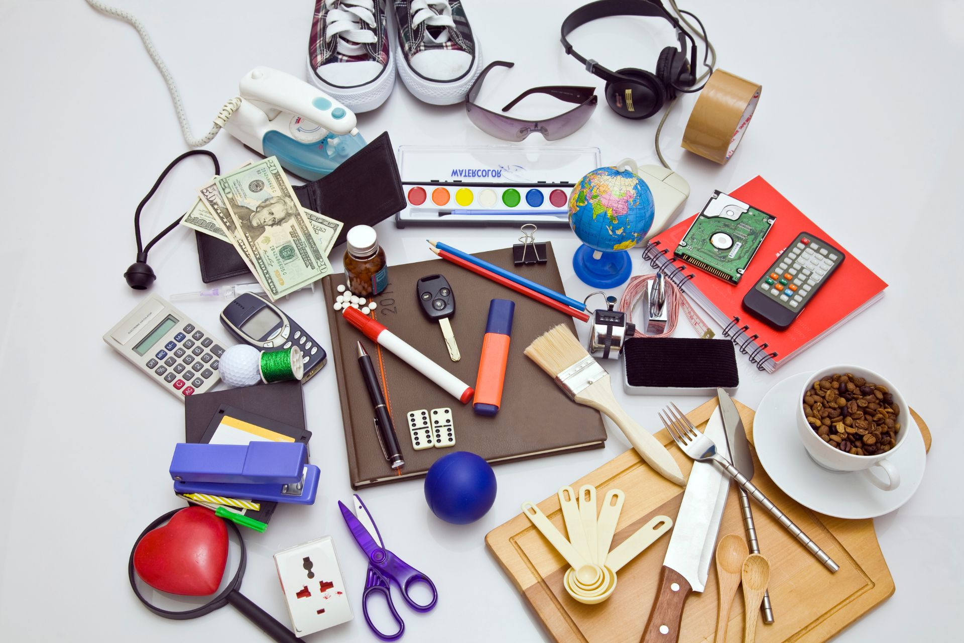 A random assortment of items, including shoes, scissors, computer hardware, and a paintbrush.